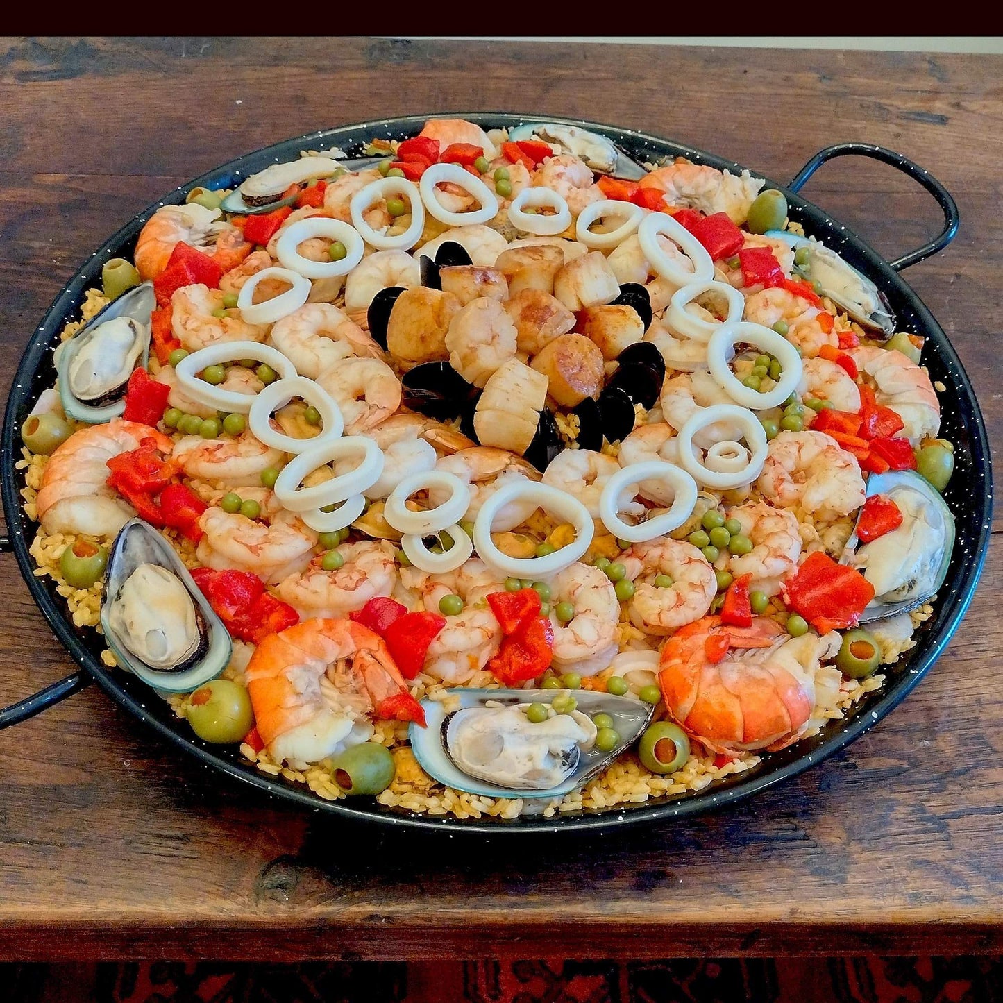 Colossal shrimp, green mussels and scallops seafood paella for 12 guests.