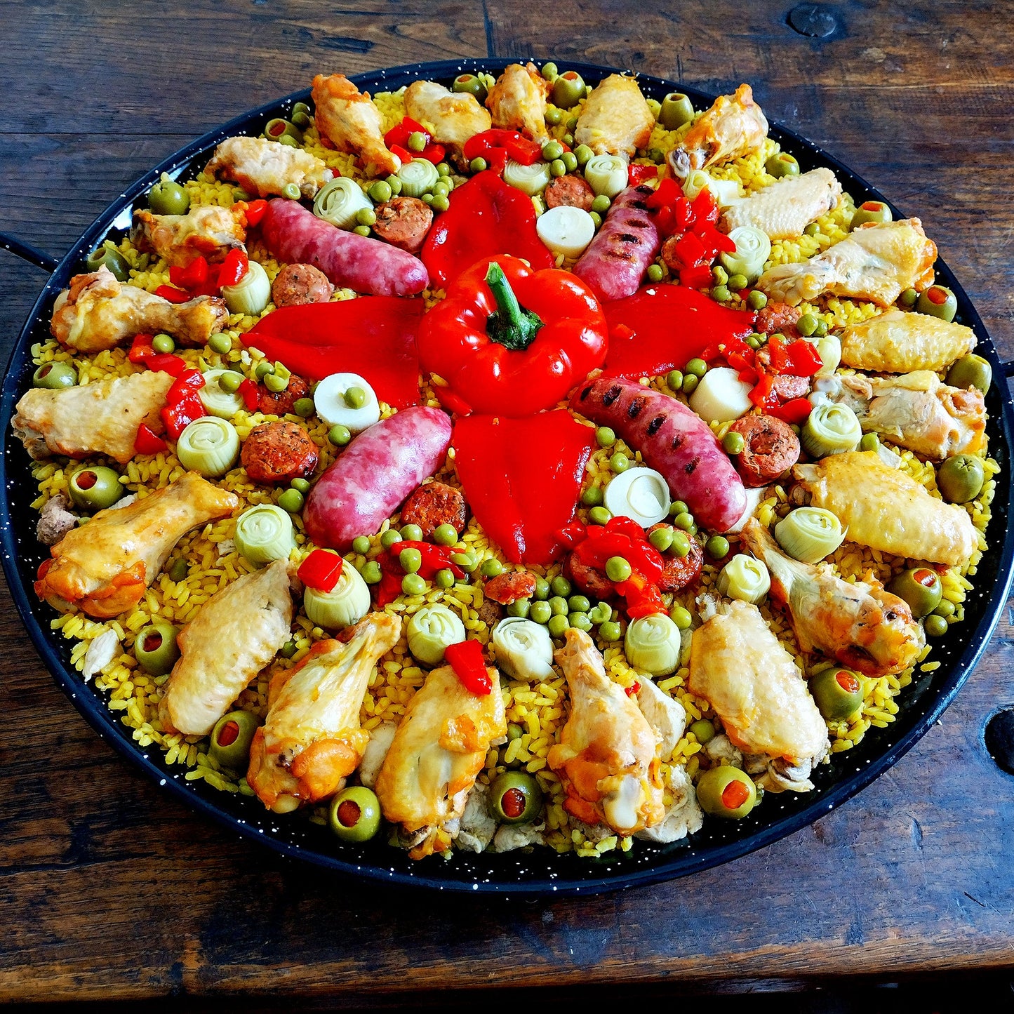 Deluxe paella. Set of six for 75 guests. Paella 2. Argentine chorizo, chicken, artichoke hearts, hearts of palm, piquillo peppers.