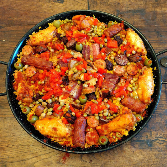 Meat lovers special paella. Colombian paisa sausage, smoked all beef wurst, Burgos morcilla, Argentine morcilla, rendered bacon, pork belly, beef ribeye,  chicken breast, chicken wings for 5 guests