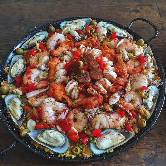 Loaded jumbo tiger prawn seafood chicken chorizo paella for 10 guests.