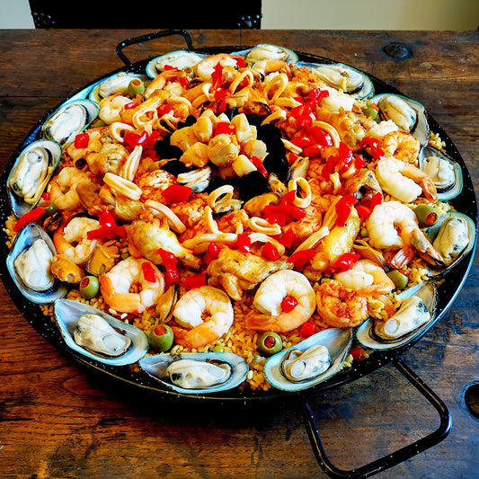 Seafood, mussels, scallops, shrimp, calamari, chicken and chorizo paella for 10 guests.