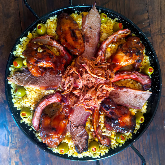 Original Paella Americana. Pulled pork, brisket, smoked chicken wings, baby back ribs and smoked sausage. BBQ paella for 4 guests.