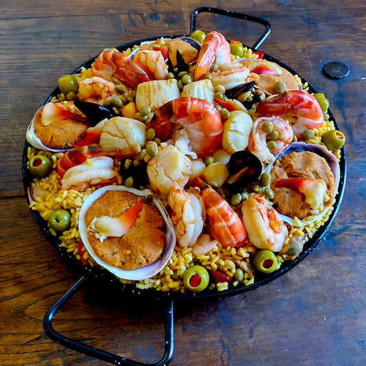 Loaded seafood Paella with colossal shrimp, Patagonia red shrimp, hand stuffed Cherrystone clams, Hokkigai clams and scallops for 6 guests.