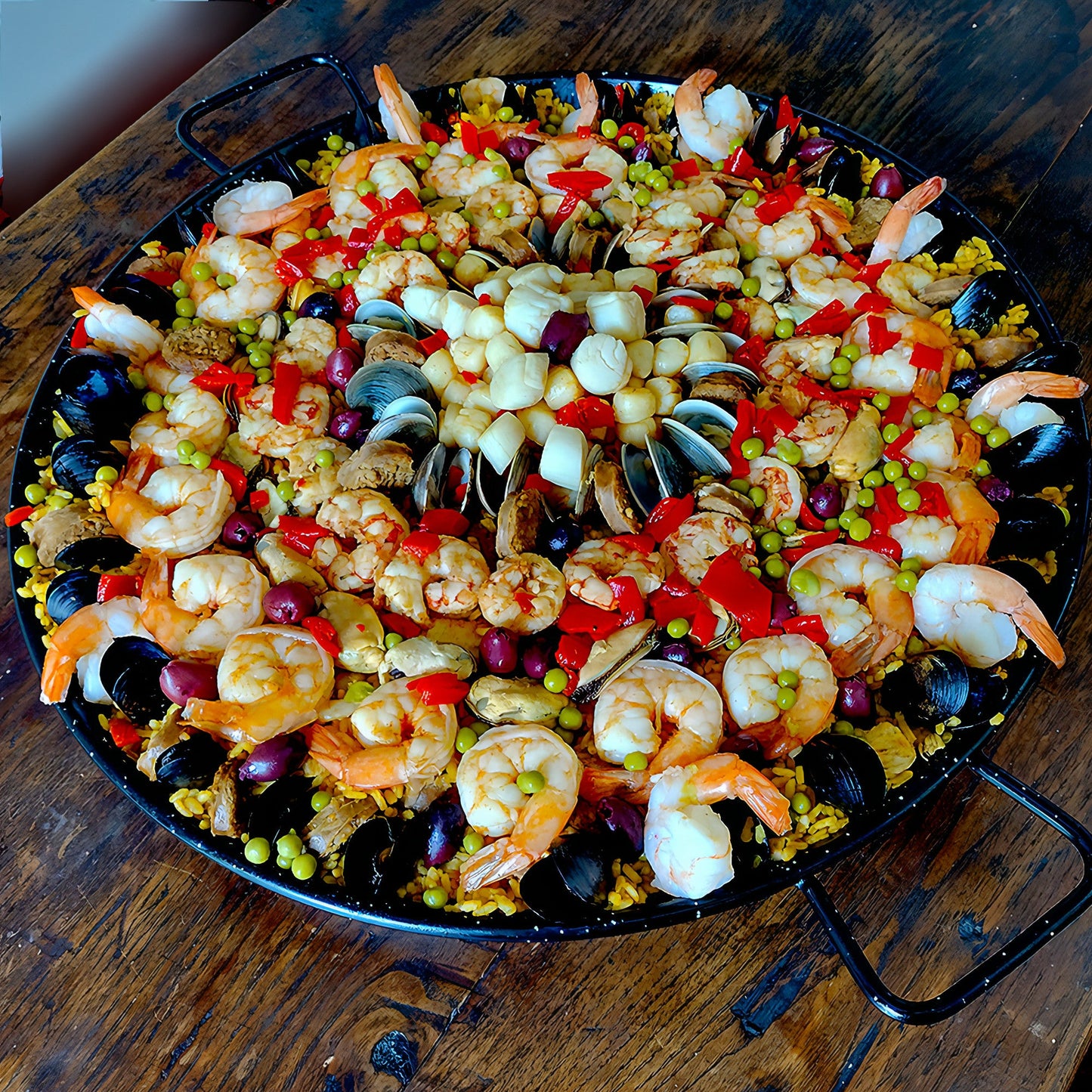 Shrimp medley, scallops, littleneck clams, mussels chicken chorizo paella for 8 guests.